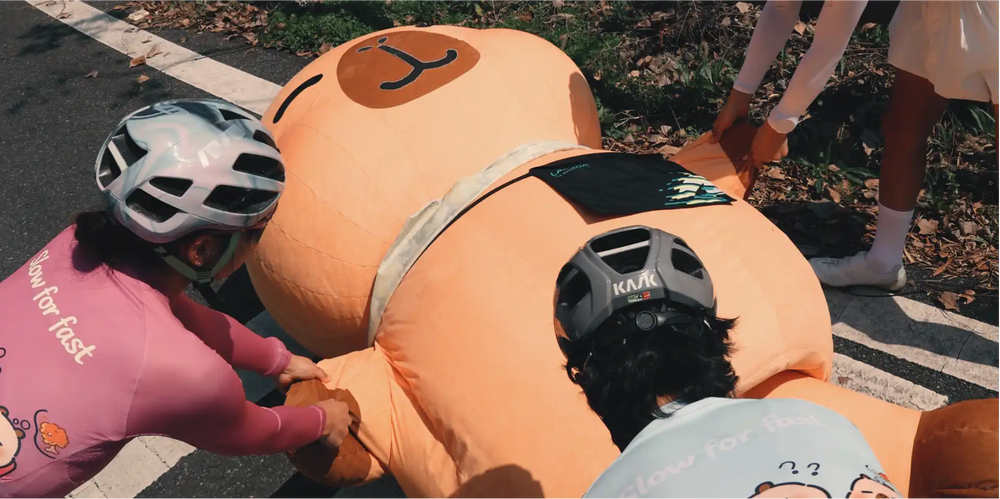 Orange inflatable bear costume from the lameda capybara collection designed to stay chill and ride slow