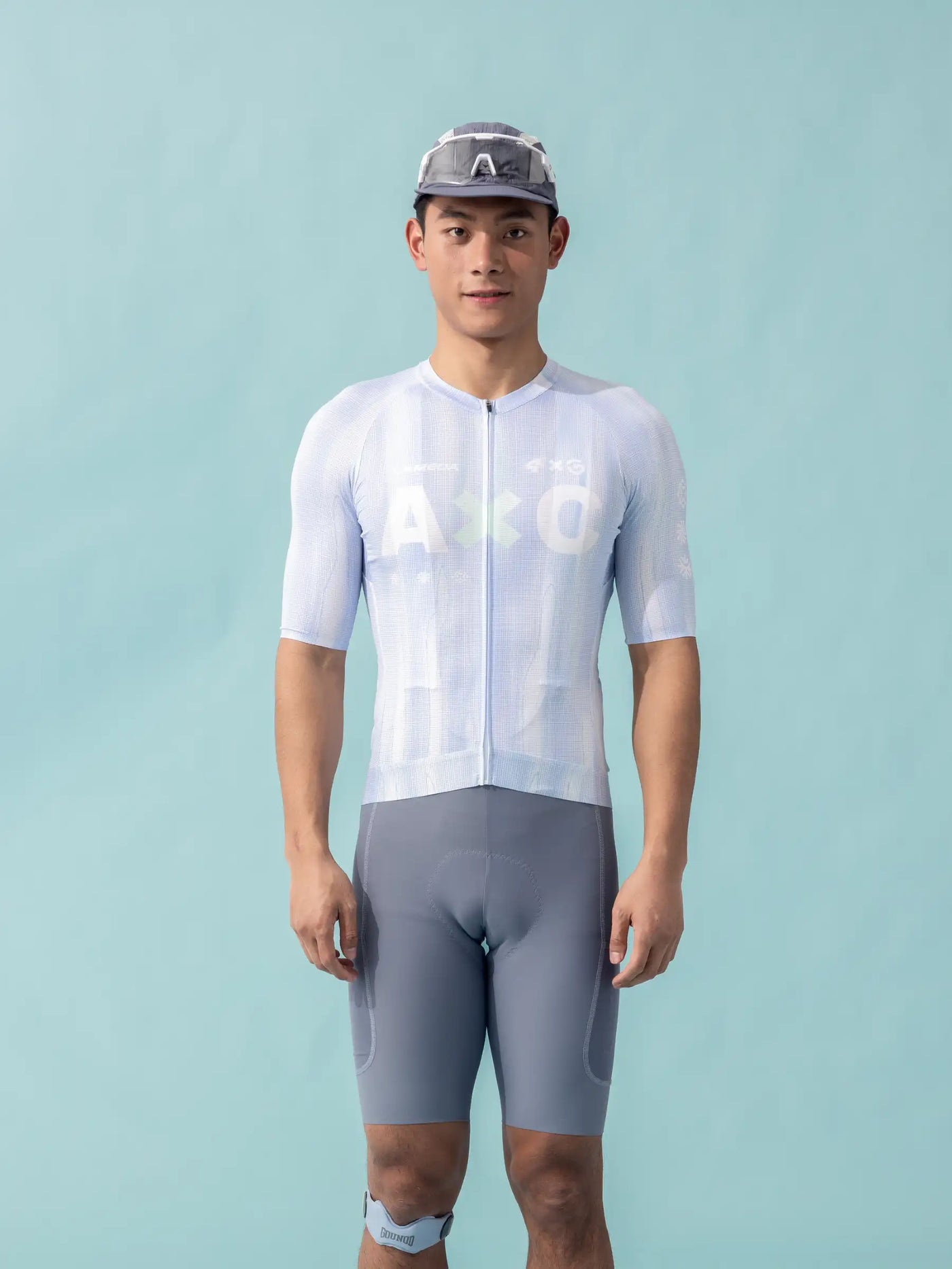 A&o ljusblå och grå unisex cykeltröja med korta ärmar och helblixtlås tillsammans med matchande shorts