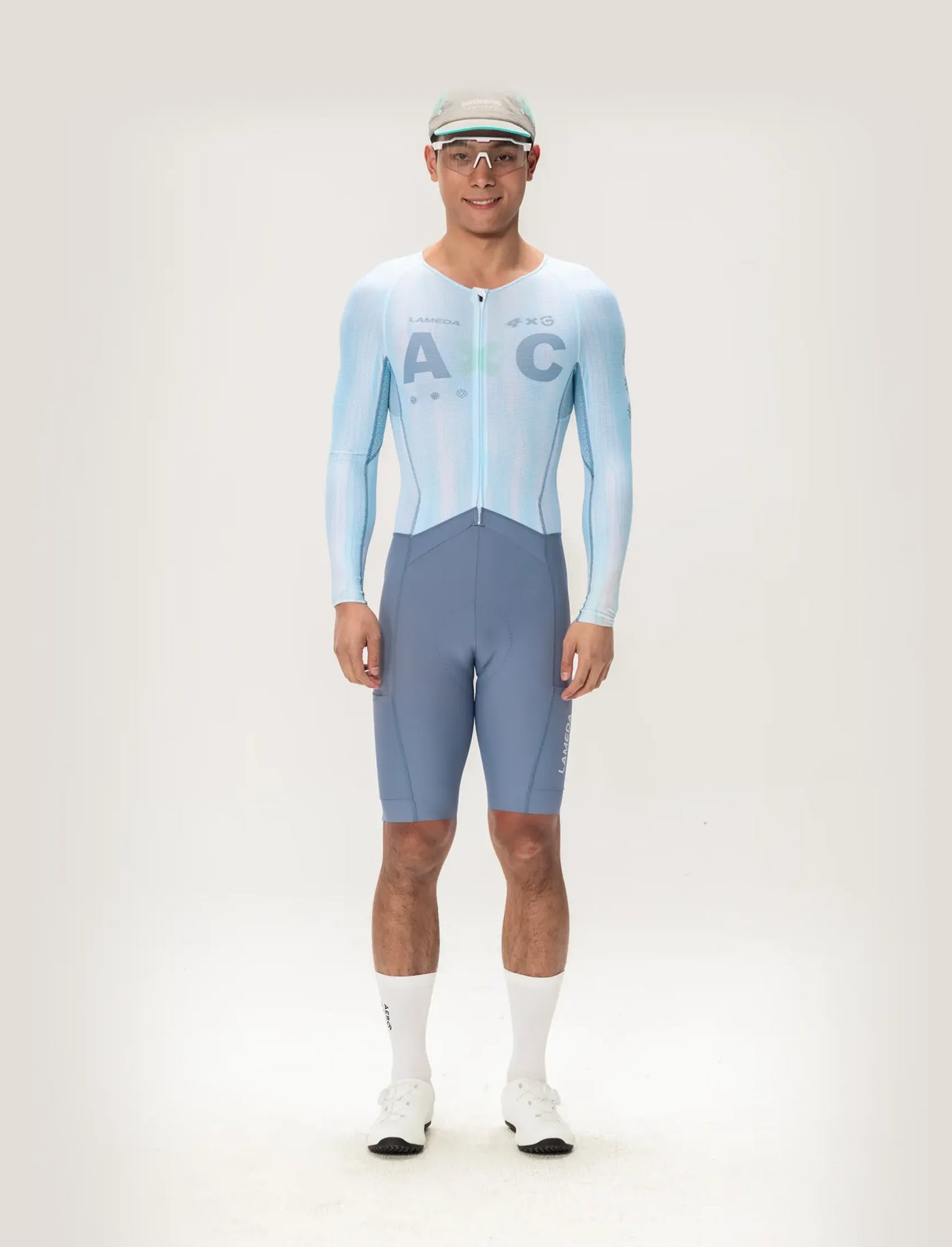 Light blue and gray long sleeve lameda ac men skinsuit featuring ac logo designed for cycling performance