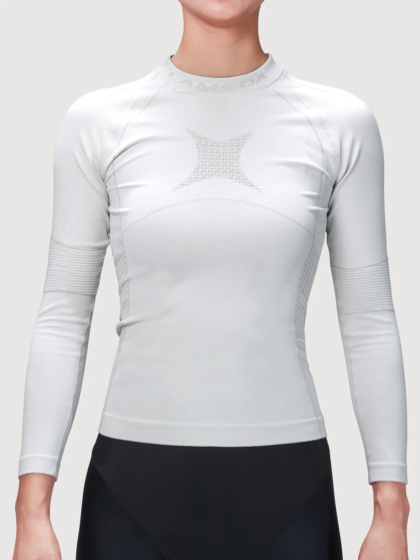 Women’s grey compression top with ribbed bamboo charcoal fiber panels for cycling compression and muscle support