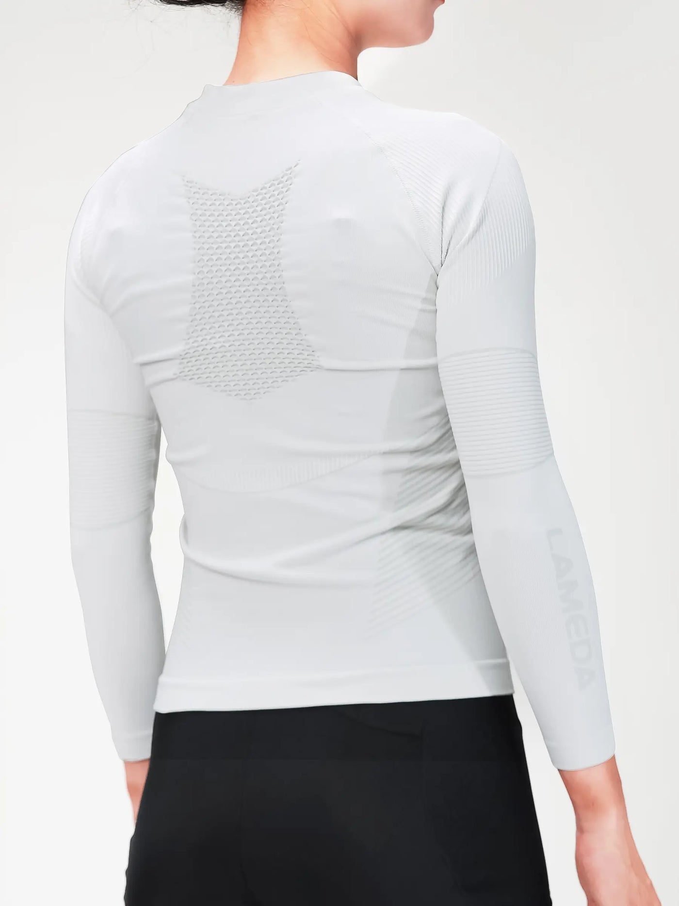 Women’s grey compression top with breathable mesh back panel and bamboo charcoal fiber for cycling compression and muscle support