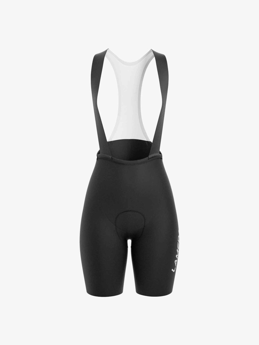 Baksida av strålande damcykelbibshorts i svart med vit panel och varumärkning på sidan för landsvägscykling
