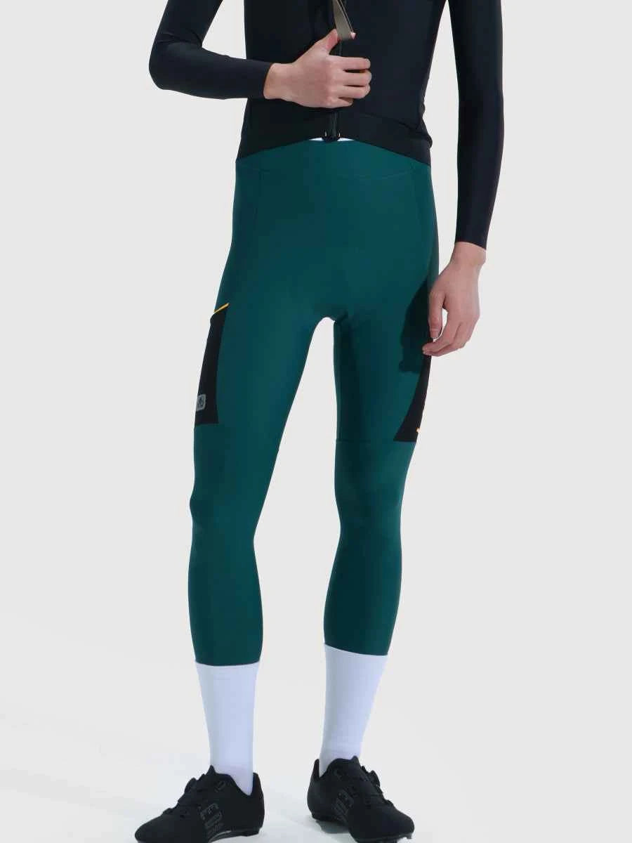 Dark green form-fitting cycling tights with black side panels and gold accents lameda serenity men’s pants