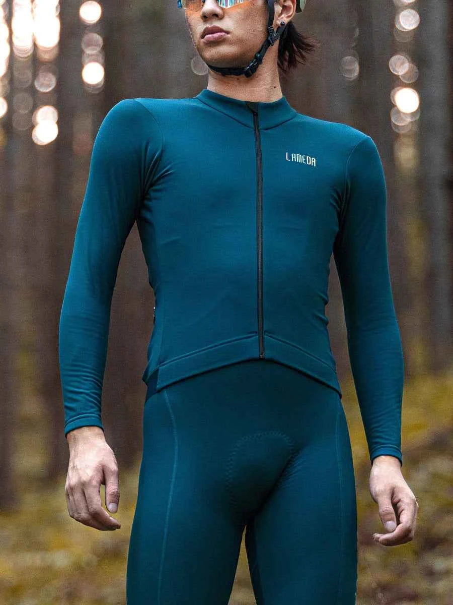 Glansig blågrön unisex termisk cykeltröja med fleecefoder, vattentäta fickor och laneca-logga på bröstet