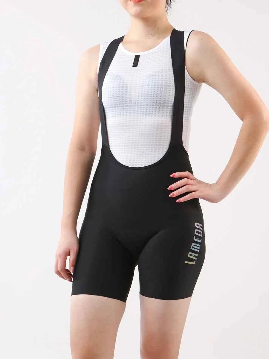Zwarte LAMEDA starlight korte fiets-bibbroek voor vrouwen met wit gaas torsopaneel en zwarte schouderbanden met 4-way stretch