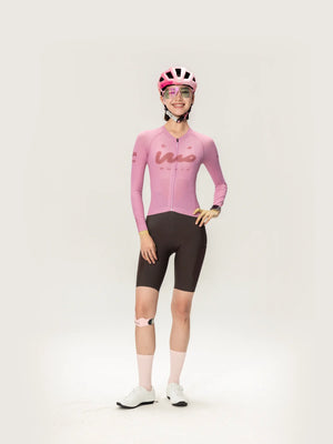 Pink long-sleeved Wow unisex cycling jersey with black shorts and matching pink helmet for lameda women’s cycling use